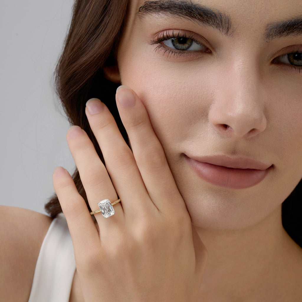 Front view Club Lux 3 Carat Elongated Cushion Ring near woman’s face, vintage-inspired glow
