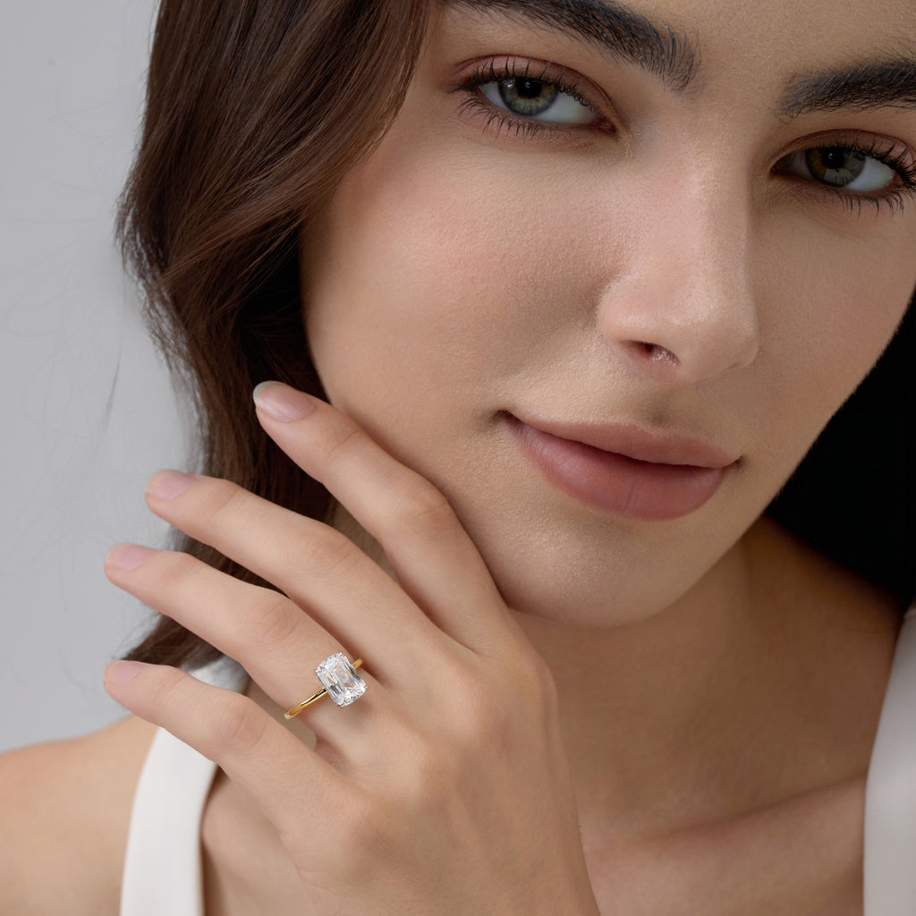 Close-up Club Lux 3 Carat Elongated Cushion Engagement Ring angled near woman’s face, refined vintage charm