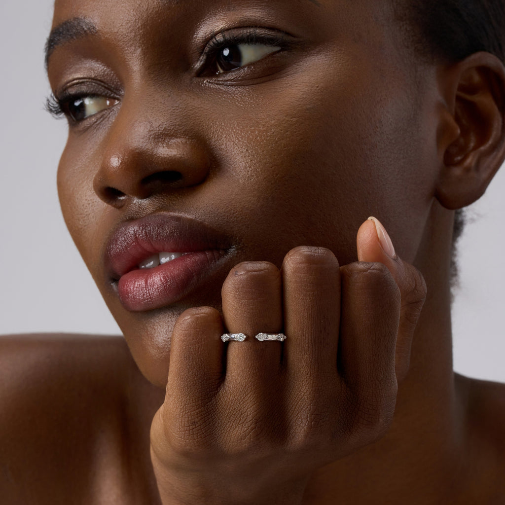Close-up of Club Lux Stackable Open Band Ring on woman’s hand, rhodium plated 925 silver, simulated diamonds.