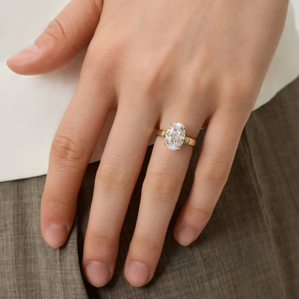 Front view of 3.5 Carat Oval Solitaire Engagement Ring worn on finger, showcasing sparkling cubic zirconia | Club Lux