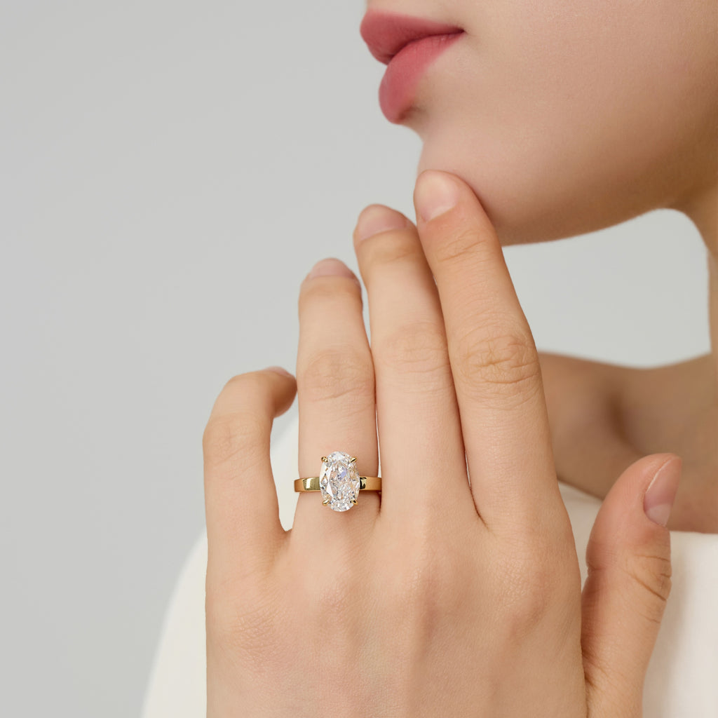3.5 Carat Oval Solitaire Engagement Ring worn on lady’s hand, touching chin, showing elegance | Club Lux