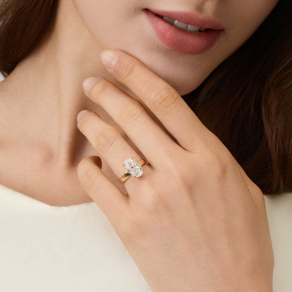 Front view of lady wearing 3.5 Carat Oval Solitaire Engagement Ring – Gold, showcasing elegance and style | Club Lux