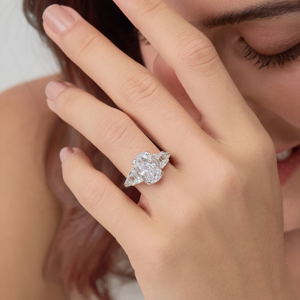 Extreme close-up of 3.5 Carat Oval Multi-Stone Engagement Ring on finger.