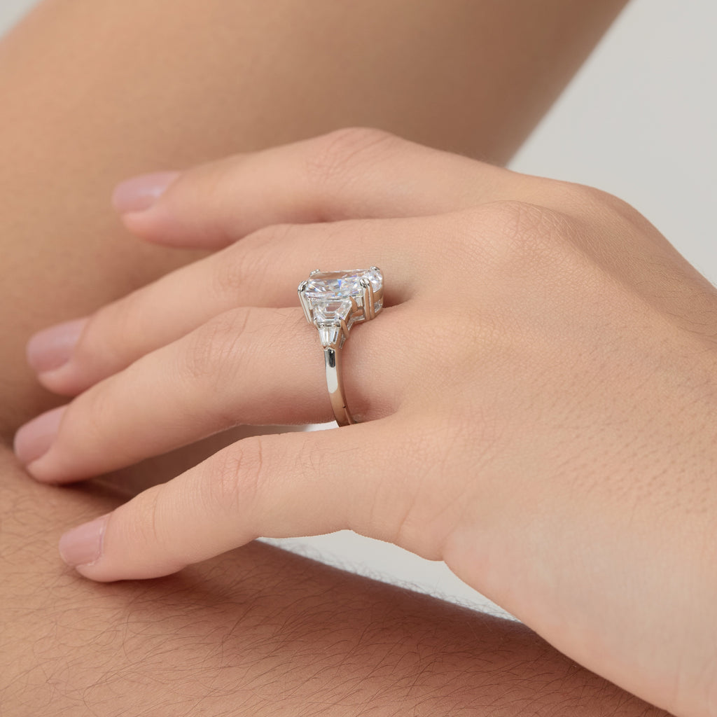 Close side view of 3.5 Carat Oval Multi-Stone Engagement Ring on woman’s finger.