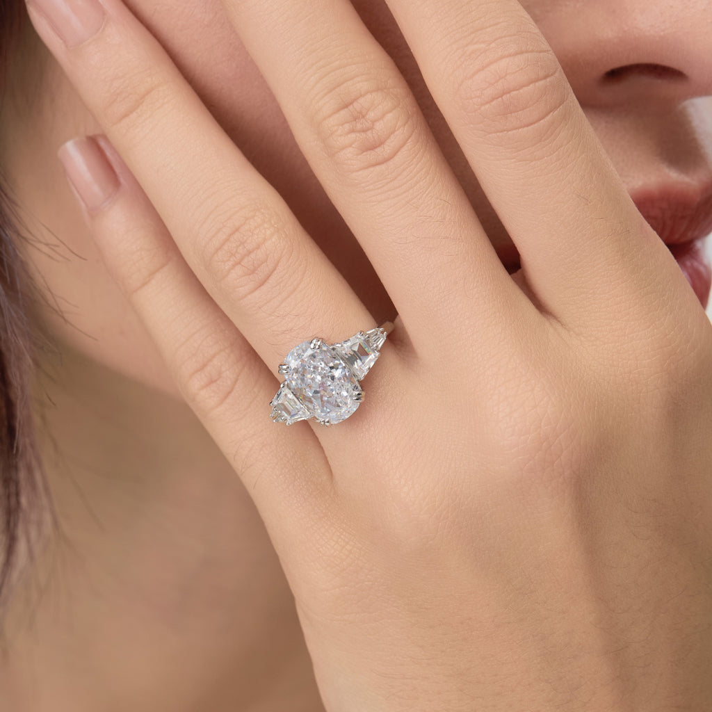Very close finger shot of 3.5 Carat Oval Multi-Stone Engagement Ring.