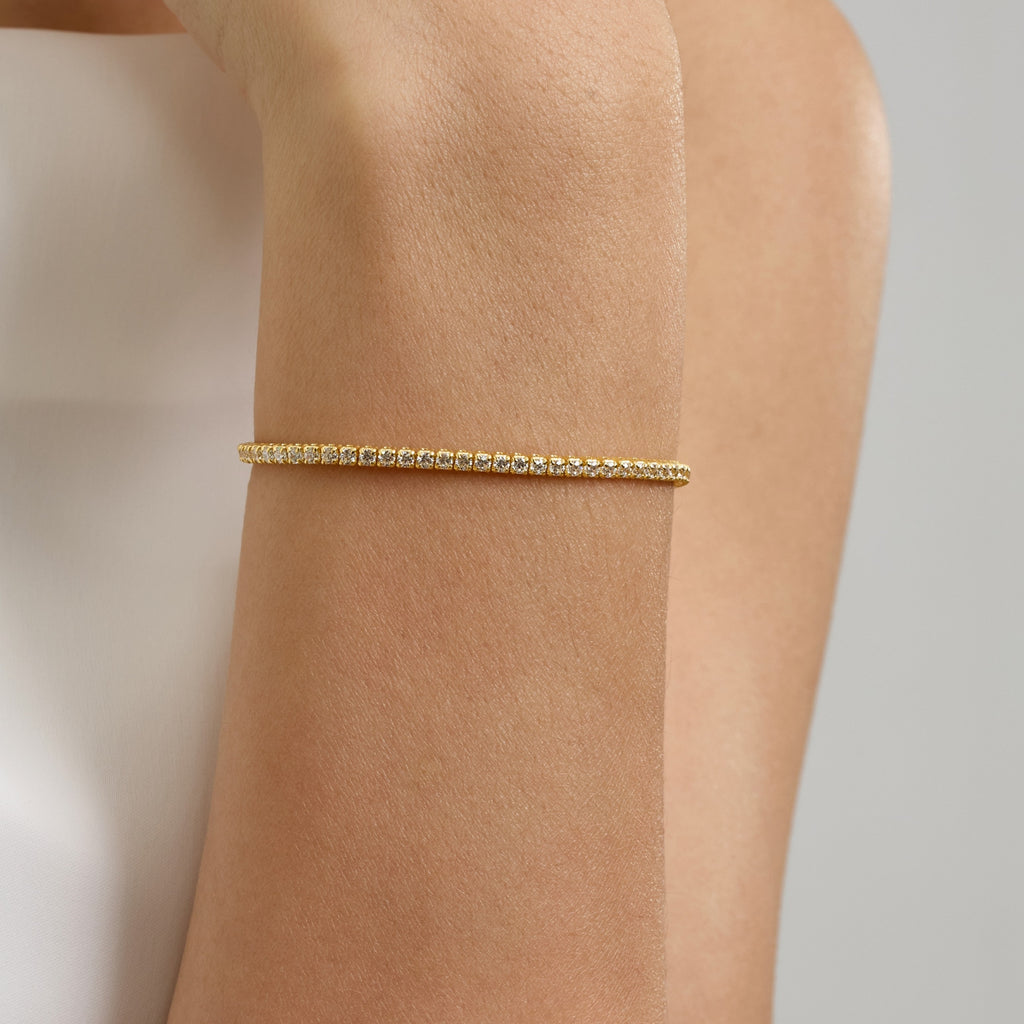 Close-Up of 2mm Gold Tennis Bracelet with Cubic Zirconia on Woman’s Wrist – Brilliant Diamond Alternative