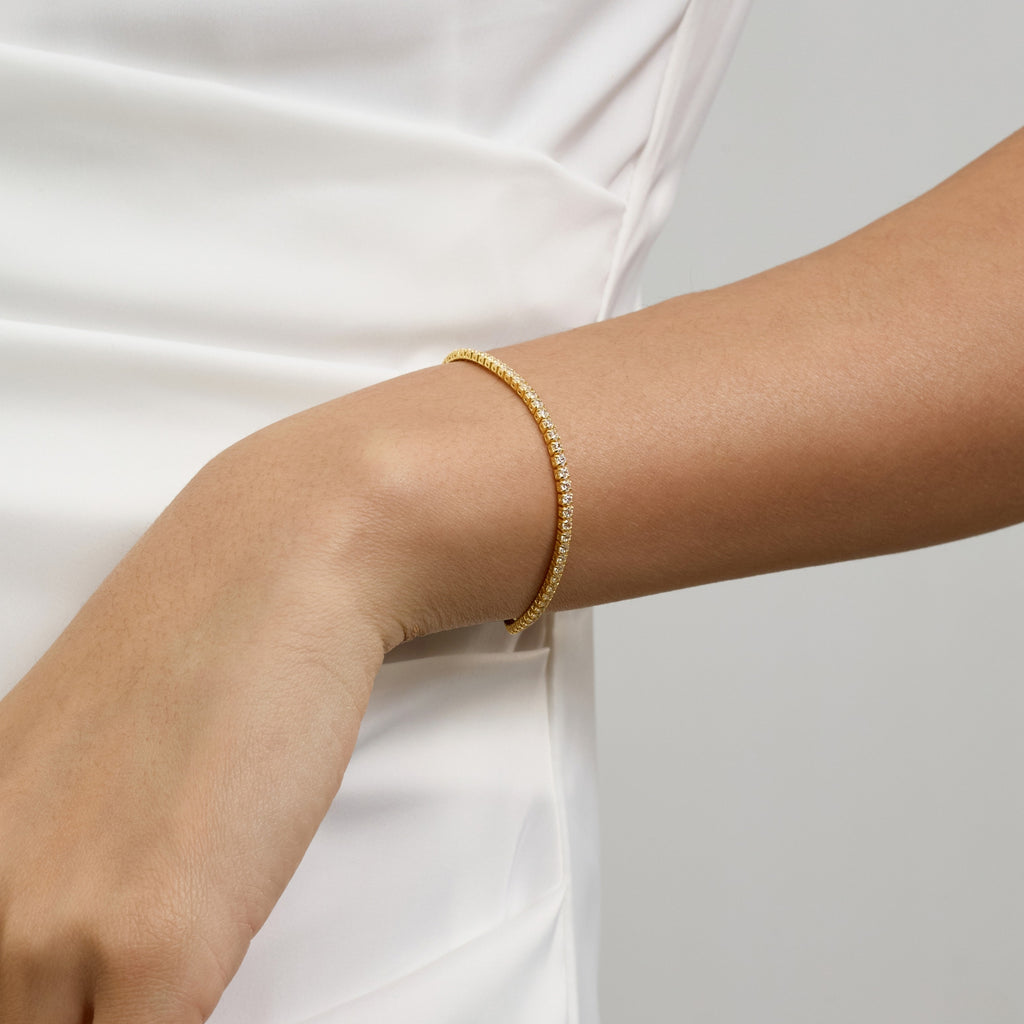 Club Lux Gold Tennis Bracelet on Woman’s Wrist with White Wedding Dress – Bridal Jewelry with Diamond Sparkle