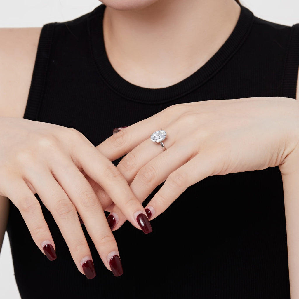 A timeless 3.5 carat oval-cut cubic zirconia solitaire ring with four-prong setting and plain band in Silver or Gold for minimalist elegance.