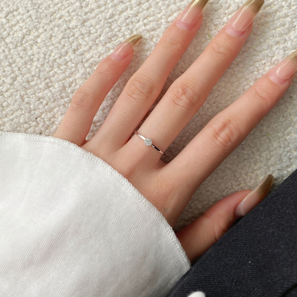Hand-set on sterling silver, this minimal baby round cubic zirconia solitaire ring sparkles day and night. Perfect for everyday wear, it can be worn alone or stack it up!