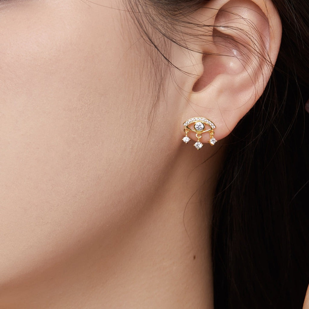 Guard against all the evil of the world with the iconic 'evil eye'🧿!   Treat yourself to these stunning golden drops studs earrings - their dazzling cubic zirconia will keep you looking stylish, while guarding you from harm! Also available as shimmering Silver Earrings!