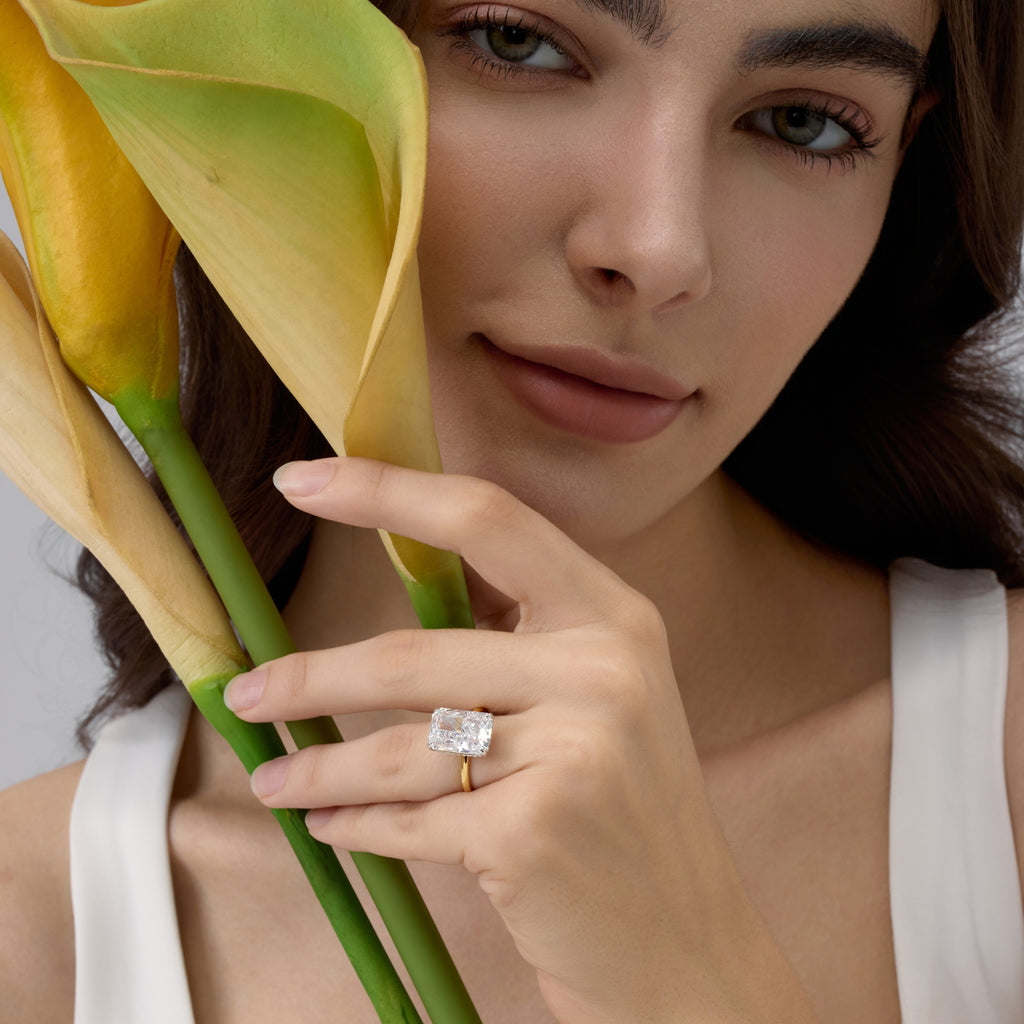 Club Lux Two Tone Radiant Cut Engagement Ring on Woman Holding Flowers – Hidden Halo Detail, 18K Gold and Rhodium Plated over Sterling Silver
