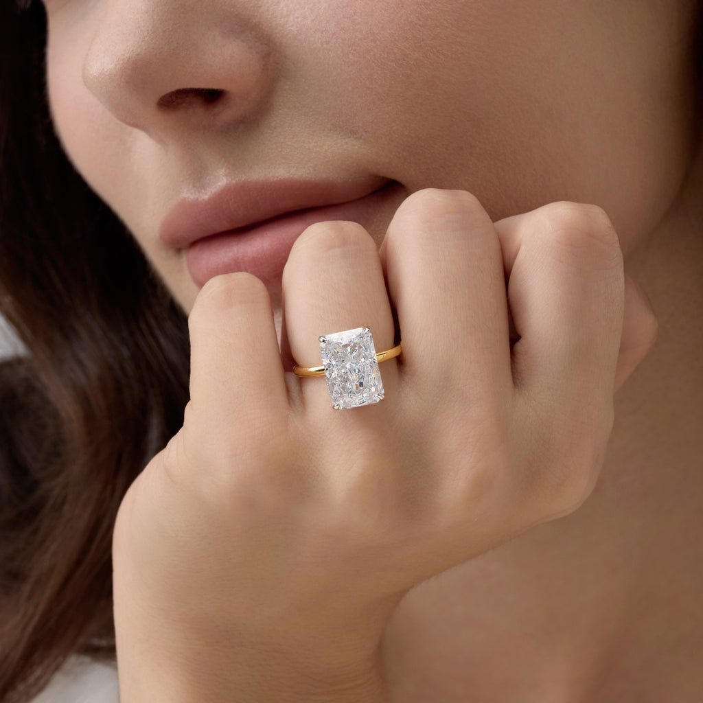 Woman wearing Club Lux Radiant Cut Two Tone Engagement Ring near her chin – 8A Cubic Zirconia Diamond Alternative, 18K Gold and Rhodium Plated