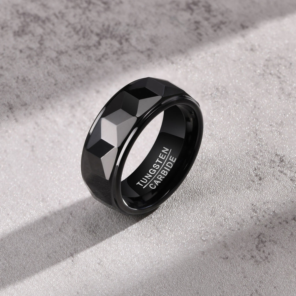 Close-up angled view of Club Lux Black Tungsten Carbide Ring, 8mm faceted surface with polished comfort-fit edge.