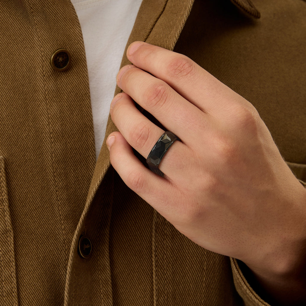 Close-up front view of Club Lux Men’s 8mm Black Tungsten Carbide Ring with faceted texture and polished finish.