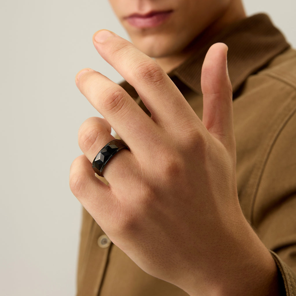 Close-up of Club Lux Men’s Black Tungsten Ring 8mm Faceted Wedding Band worn on hand, highlighting geometric texture.