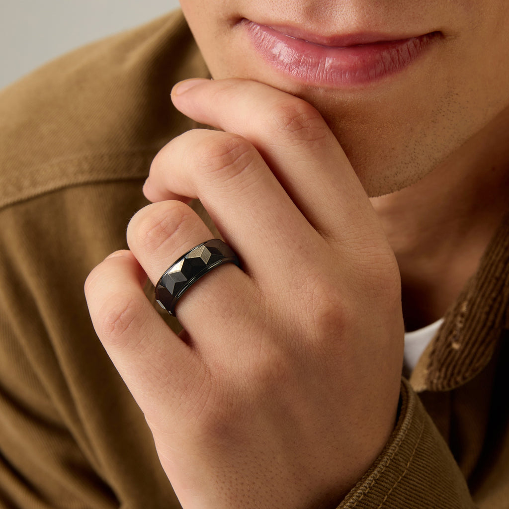 Men’s Black Tungsten Ring by Club Lux worn on hand near chin, showing 8mm faceted design and masculine style.