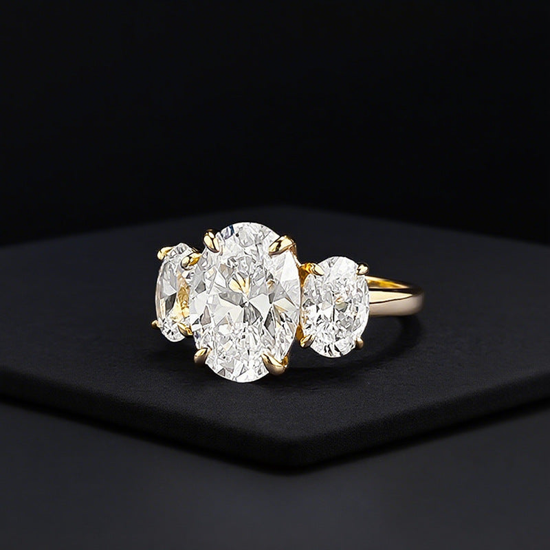 Front and side view of 4ct TW oval trilogy engagement ring in gold.