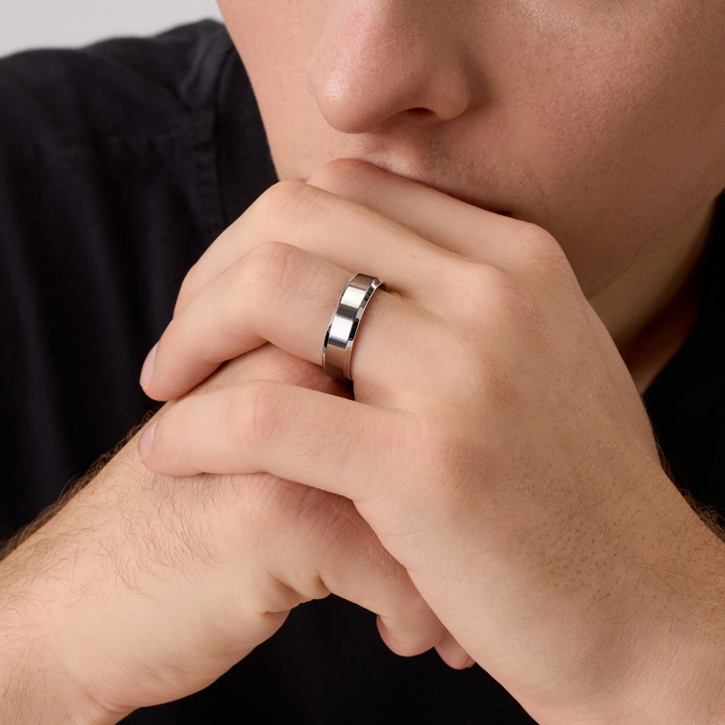 Close-up of man wearing a silver titanium wedding band