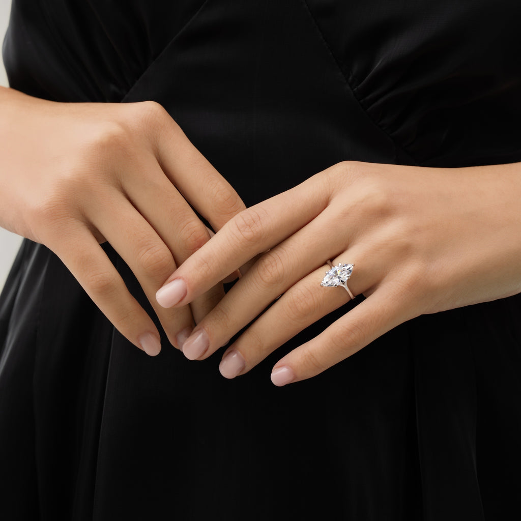 Marquise Cut Engagement Ring on hand with black dress background – side-front angle emphasizing sparkle and sophistication.