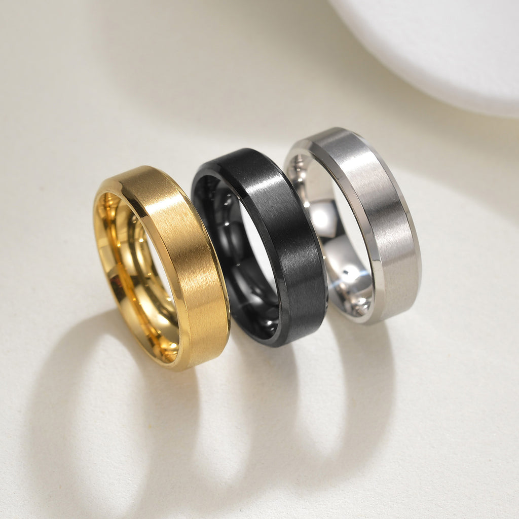 Men’s titanium wedding bands in yellow gold, black, and silver colour options