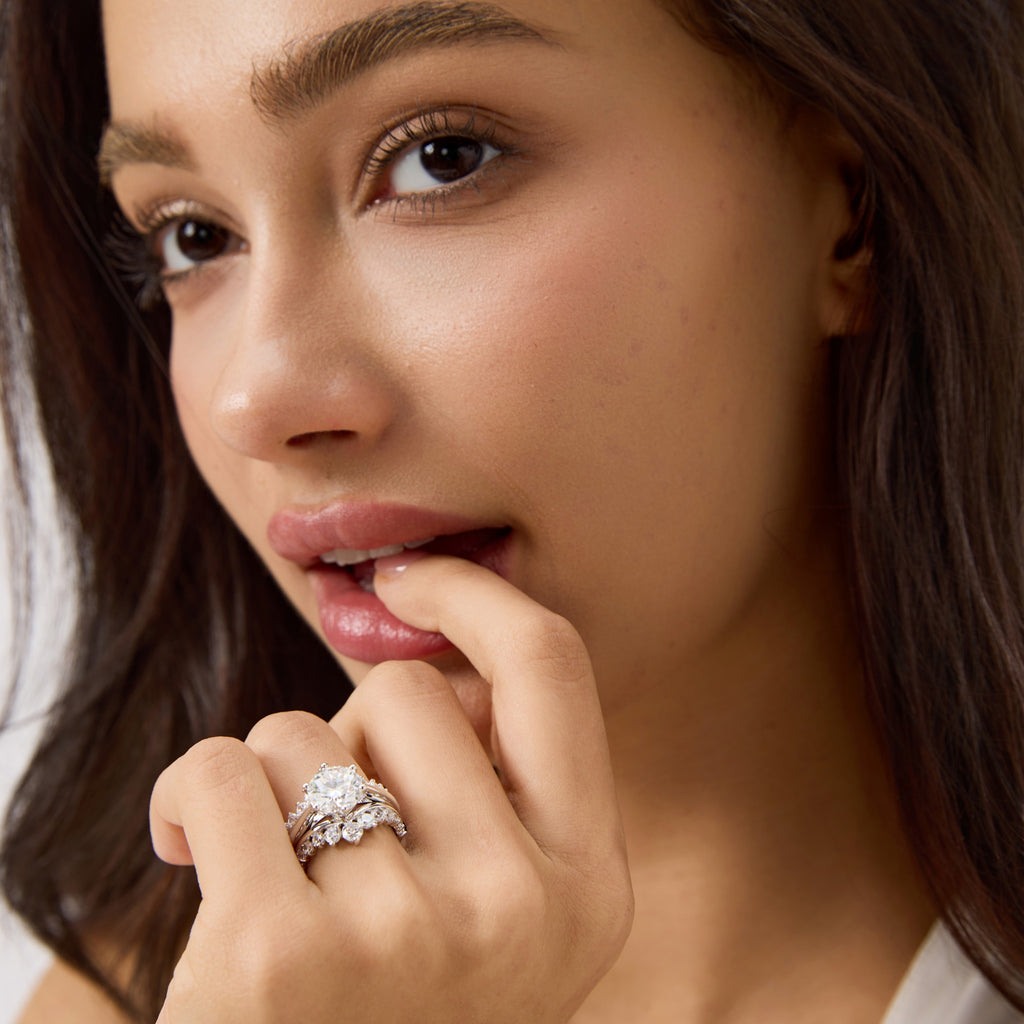 Close look at woman wearing 3 carat round moissanite bridal ring set.