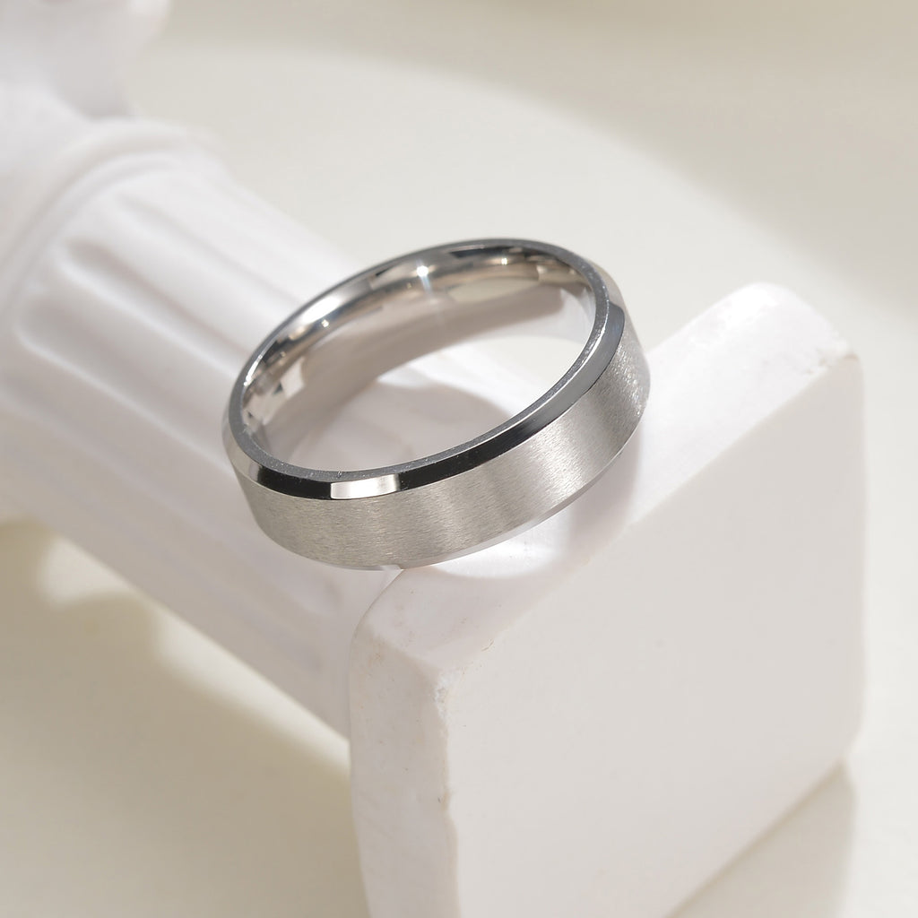 Top and front view of men’s silver titanium wedding band showing inside and outside design